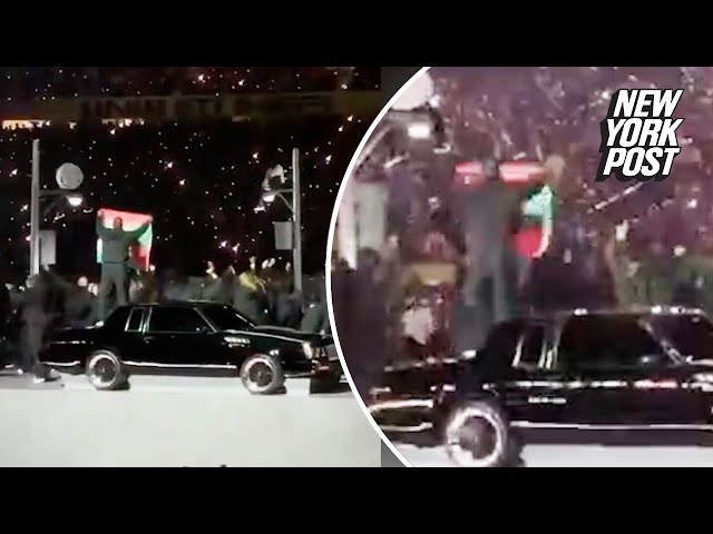 Protestor holds up Palestine, Sudan flags during Super Bowl 2025 halftime show