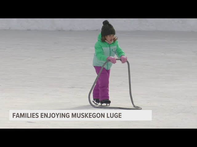 Families enjoying cold weather, snow at Muskegon Luge