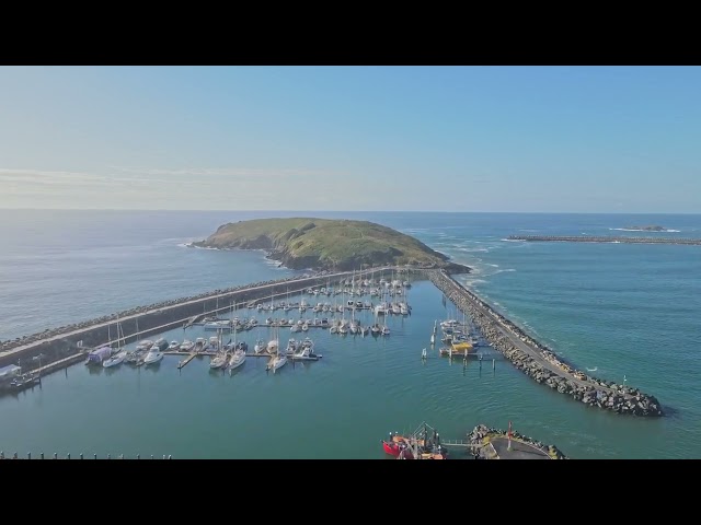 Flying over Coffs Harbour's Jetty beach toward the little island next to the Marina