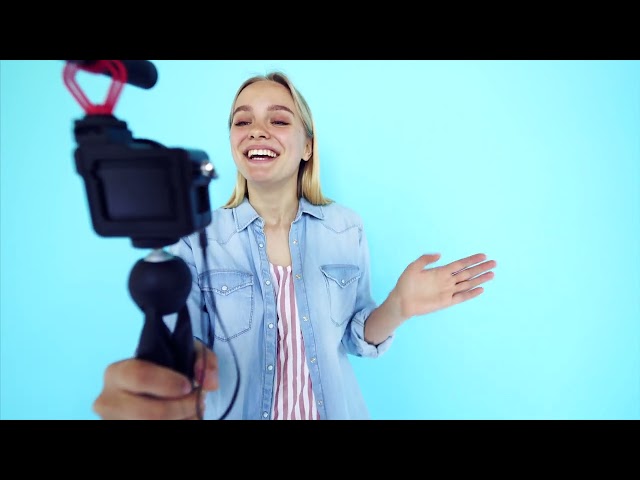 Vlogger uses camera and selfie stick to record video blog in 