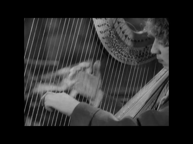 1929: Harpo Marx plays the Harp