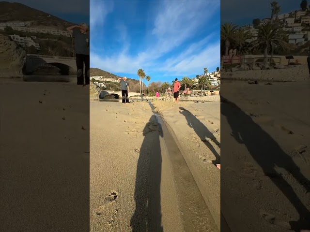 Little Girl Digs Trench Connecting River To Ocean