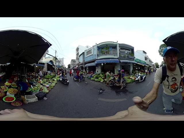 Dodging Motorbikes At A Chaotic Street Market In Saigon, Vietnam