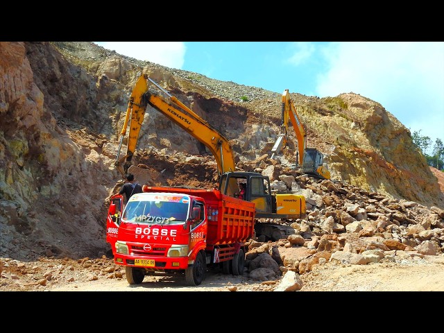 Excavator Using Hydraulic Breaker And Bucket To Dig And Loading Dirt Into Dump Trucks