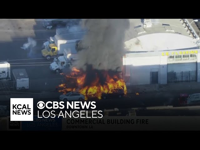 Fire spreads to two cars, commercial structure in downtown LA's Fashion District