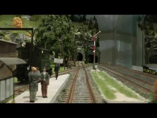 Cab ride on a mountain model railway layout with tunnel and track spiral