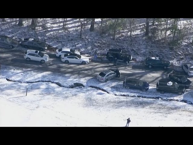 Drivers try to reunite with towed cars after being forced to abandon due to icy road conditions