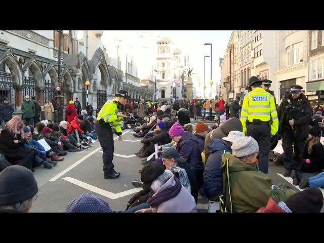 Climate activists block road in sit-in protest outside London court | AFP