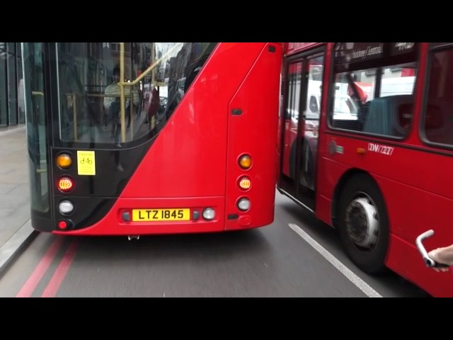 Cycling between the double-decker buses in London traffic jam