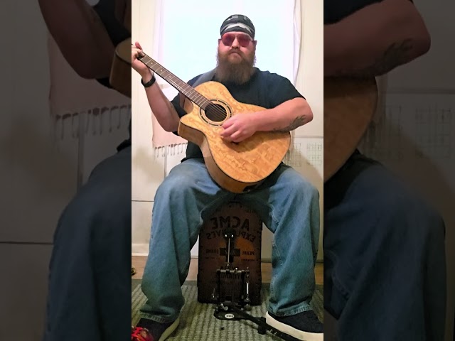 Just a dude playing a guitar, while playing a cajon, and foot tambourine.