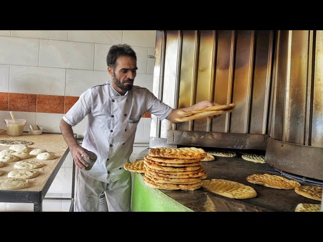 The beautiful movements of this baker with Barbari bread dough are really spectacular|baking bread