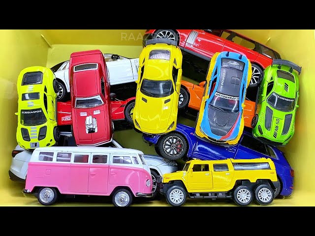 Box full of various miniature cars Peugeot, Volvo, Renault, Hyundai, Pagani, Cadillac One, DHL 13