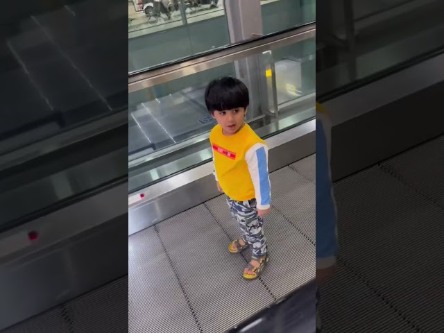 3 years baby trying to defeat fear on escalator and successfully rides after multiple falls #funny