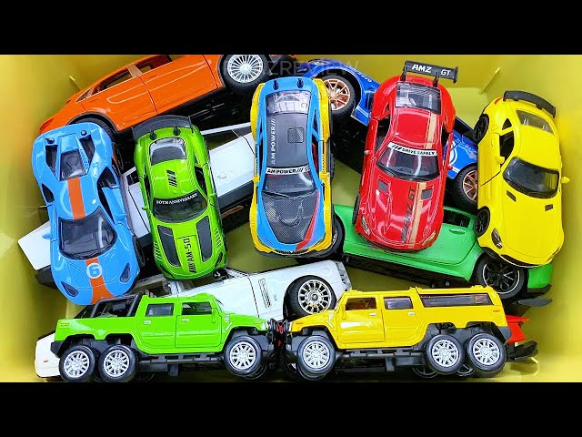 Box full of various miniature cars Peugeot, Volvo, Renault, Hyundai, Pagani, Cadillac One, DHL 13