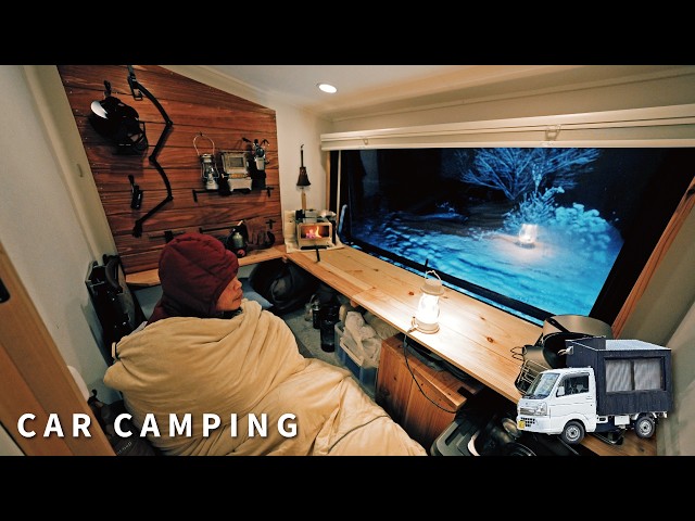 Car camping in the harsh snowy mountains. The new homemade light truck camper is comfortable.