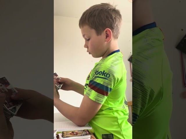 Alfie showing his football cards and Guinness world record book