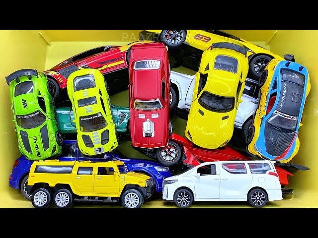 Box full of various miniature cars Peugeot, Volvo, Renault, Hyundai, Pagani, Cadillac One, DHL 13