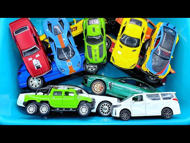 Box full of various miniature cars Jaguar, Peugeot, Renault, Hyundai, Mazda, Volvo, Honda, Opel