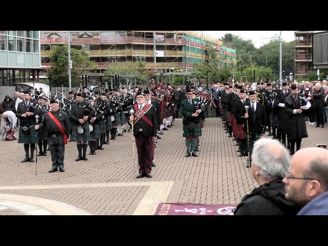 Football fans supported by pipes & drums celebrate Heart of Midlothian 150 Years, Edinburgh Scotland