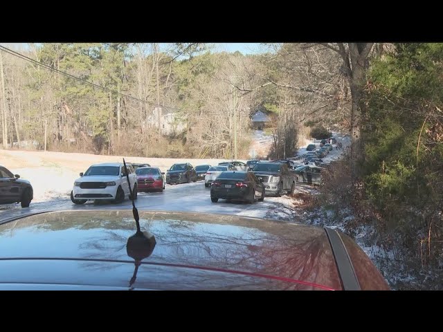 Cars abandoned on the side of ice-covered roads in metro Atlanta