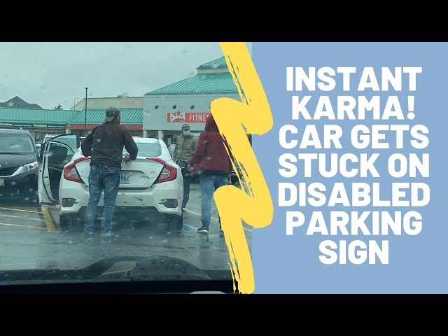 Instant Karma as man drives over disabled parking sign and gets stuck