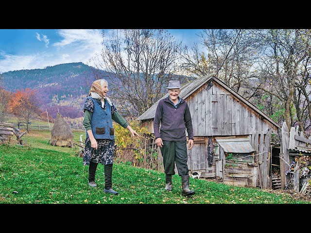 Happy old age of an elderly couple in a mountain village far from civilization