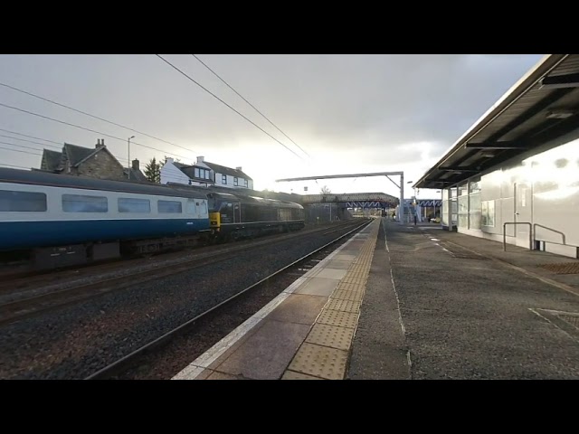 Transpennine express passes Charter train at Carstairs on 2022/04/08 at 1900 in VR180