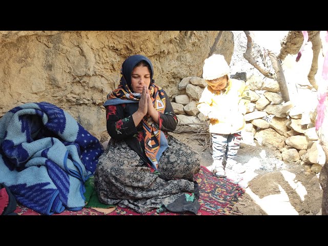 Escaping from the cold of winter, living in a mountain cave, Zahra and her son collecting firewood