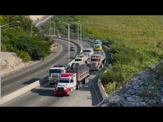 Trucks navigating uphill on a 7.6% grade with heavy loads. S9-E5